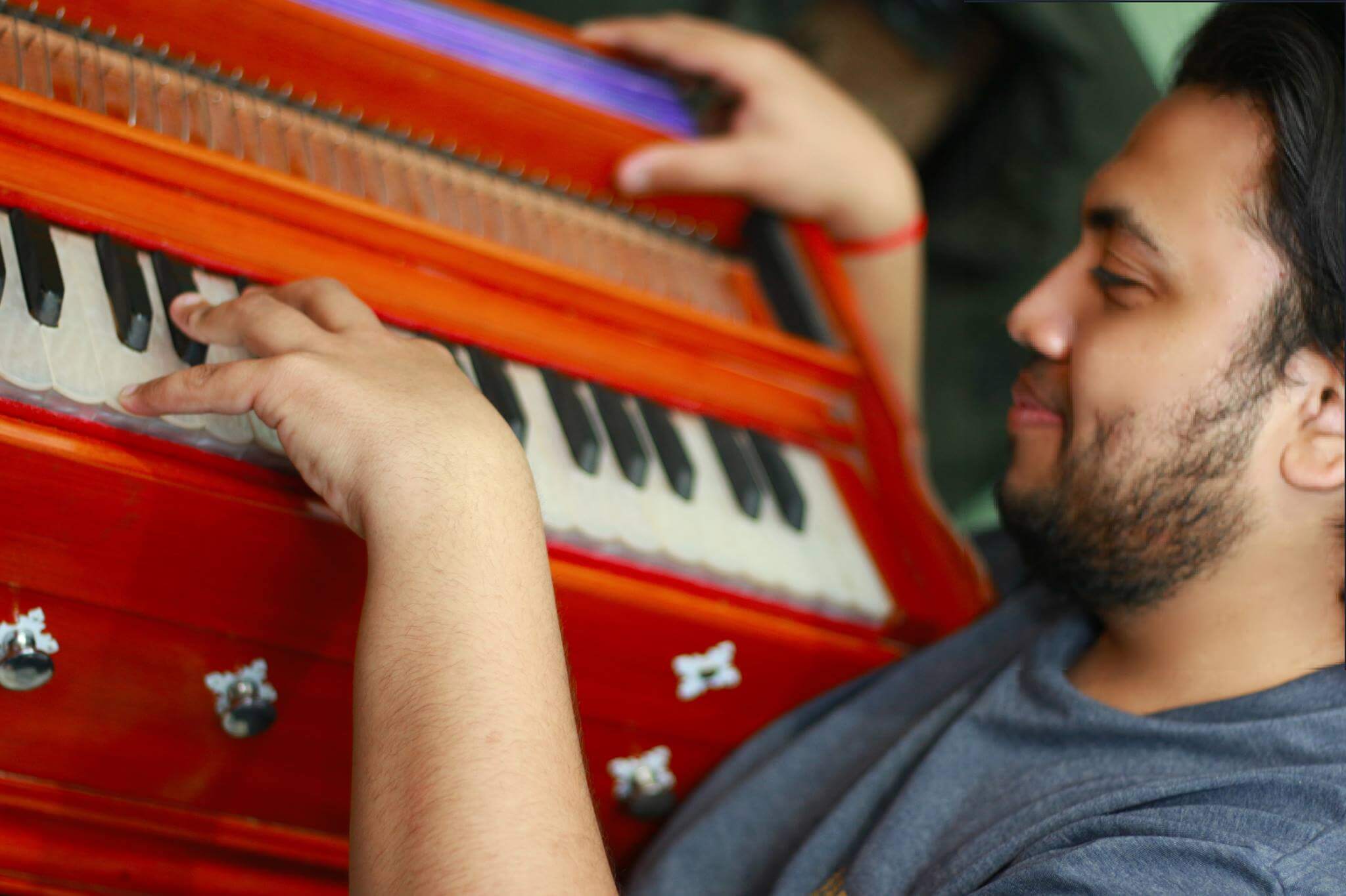 a picture of Faraz Qadir doing practice on a harmonium